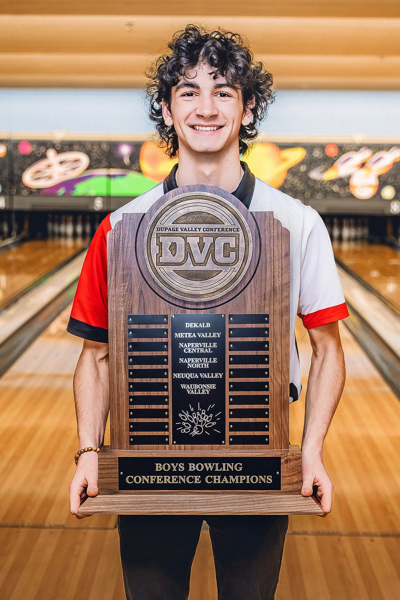 Sean Mulvey holding the DuPage Valley Conference Boys Bowling Champions trophy