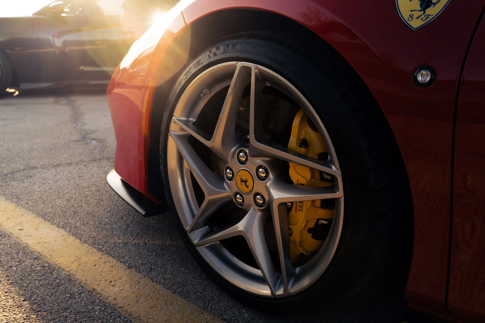 Ferrari wheel and brake caliper in golden light
